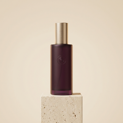 FRISSON cleansing mist bottle on a cream pedestal